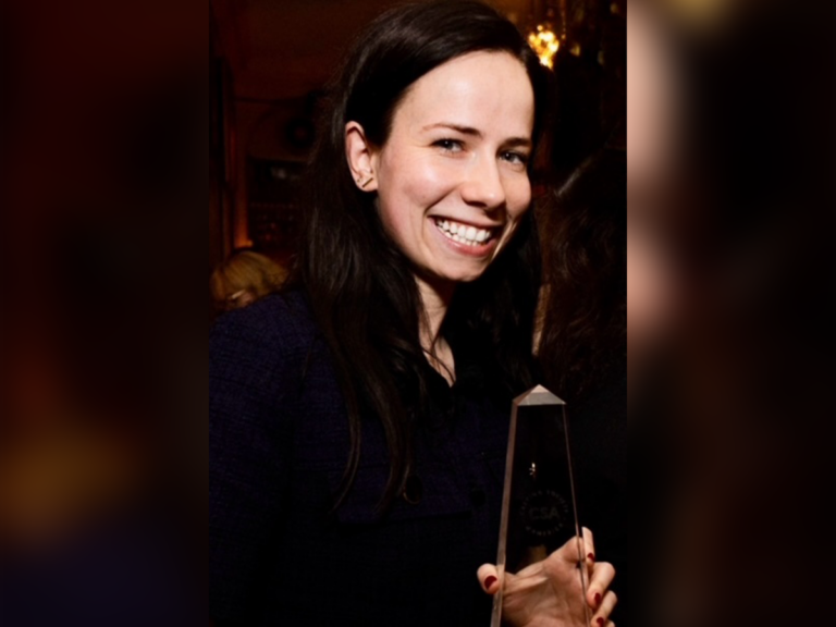 Casting director Emily Brockmann smiling with a trophy