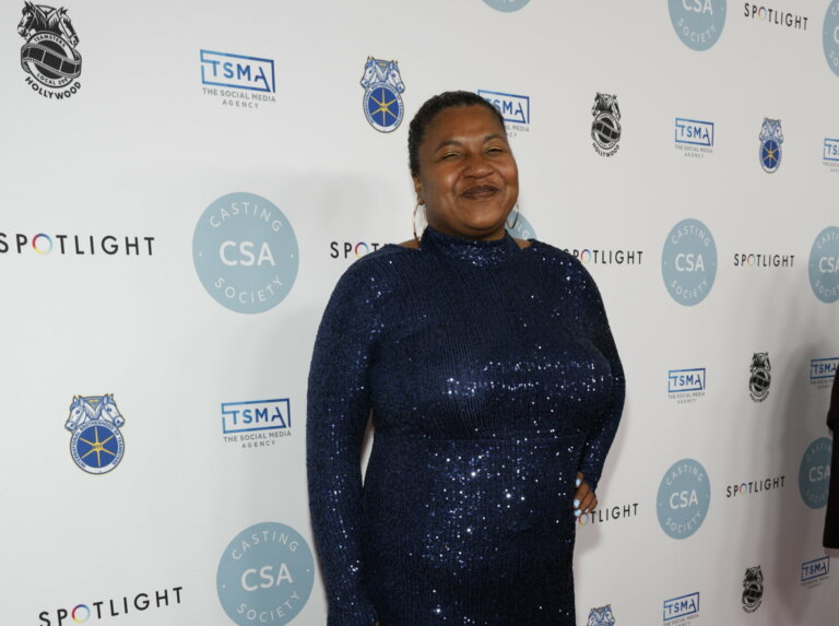 Destiny Lilly at Casting Society's (CSA) 39th Annual Artios Awards in a blue dress smiling.
