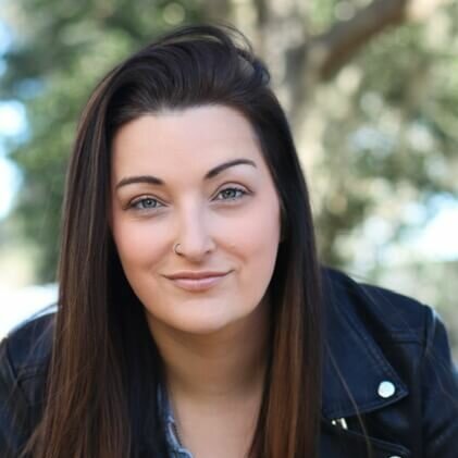 Karlie Loland-Ringer in a leather jacket outside smiling.