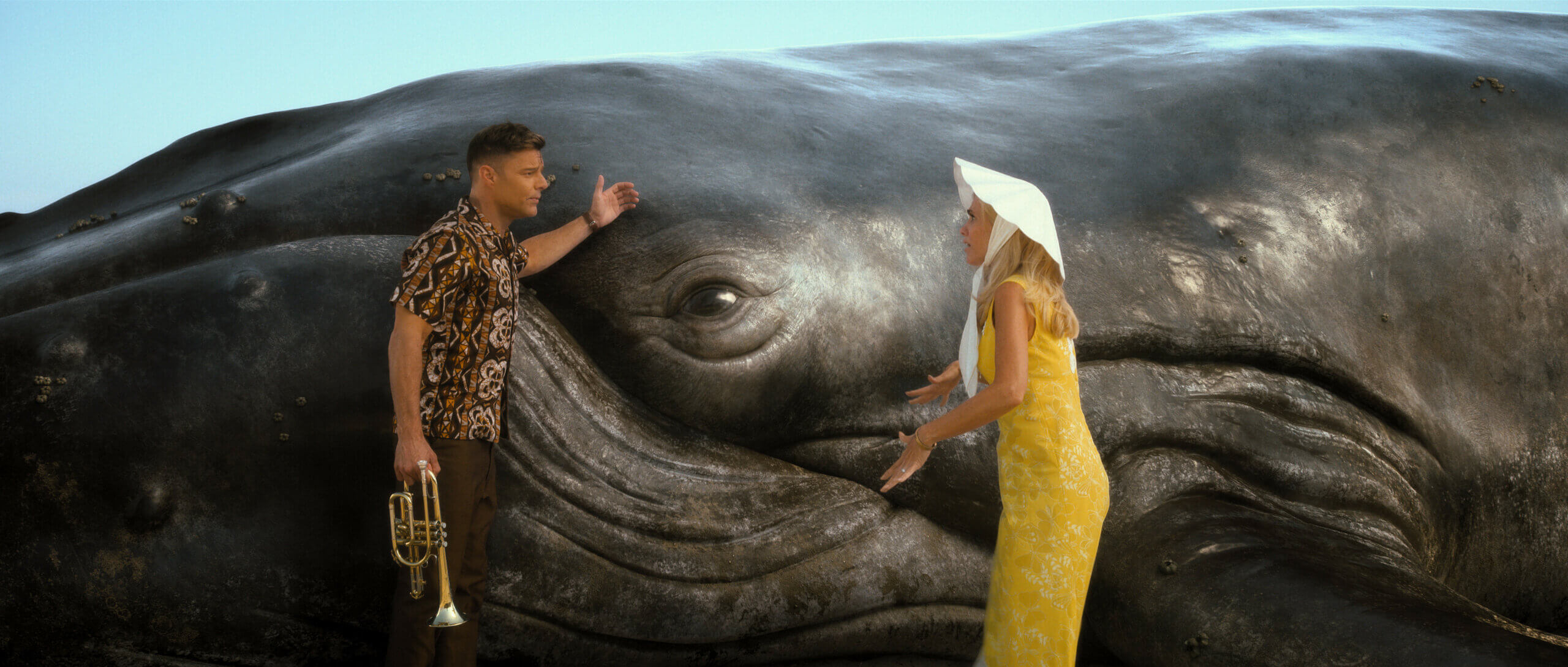 Kirsten Wiig and Ricky Martin next to a whale.