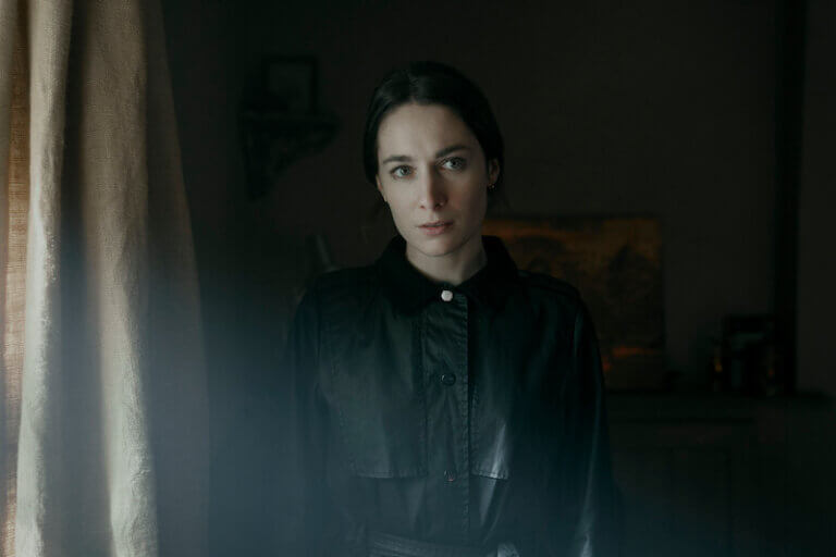 Siobhán Cullen in a black outfit inside looking timid.