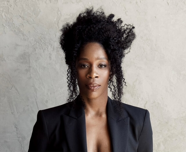 Chantal Nchako in a black open blazer smiling.