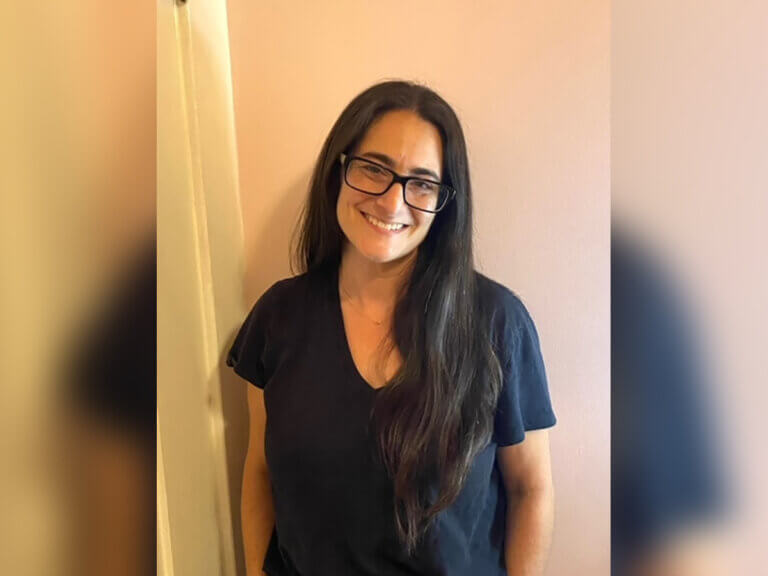Jennifer Ricchiazzi standing in a hallway smiling.