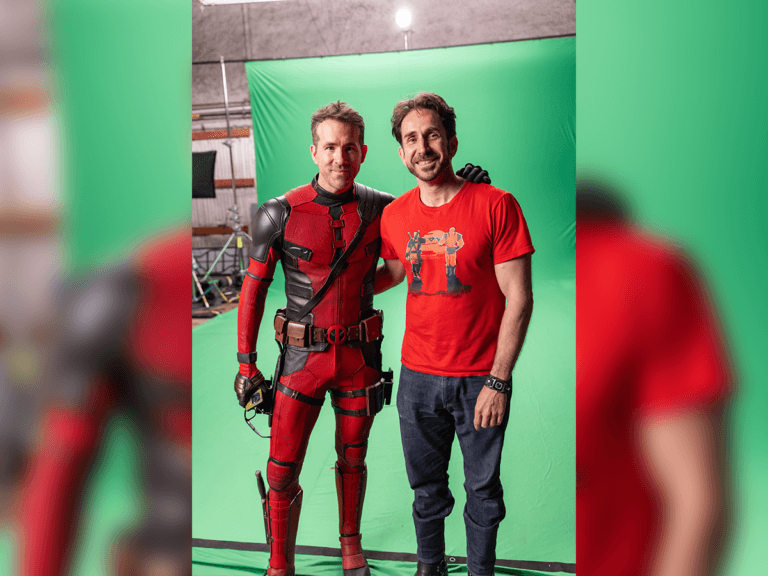 Nathan Reid and Ryan Reynolds as Deadpool in front of a green screen.