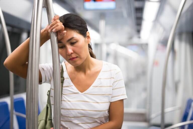 Asian woman on the train experiencing burnout.