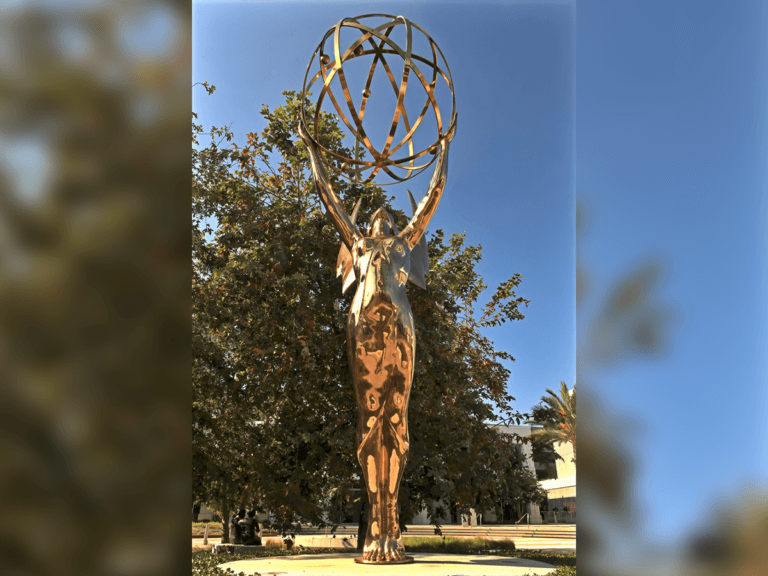 Giant Emmy Award statue on a sunny day.
