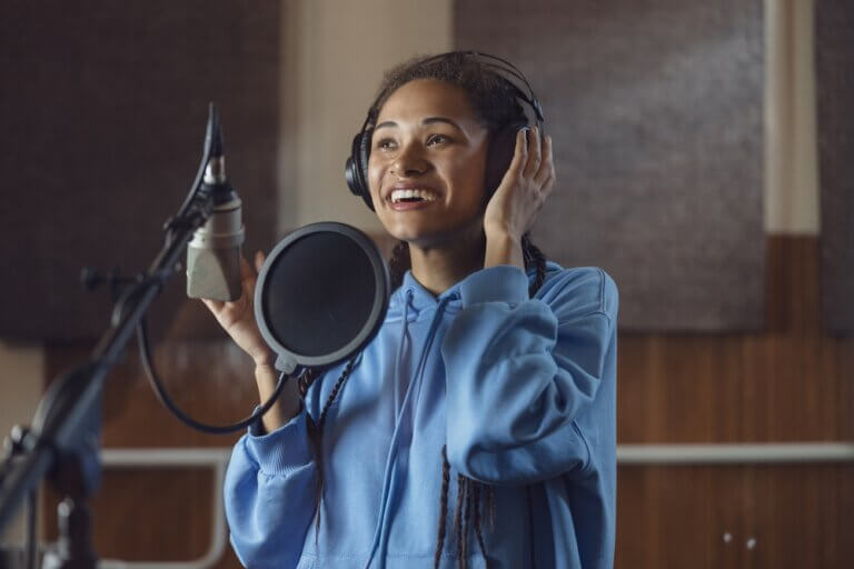 Female voice actor recording in a professional recording studio.