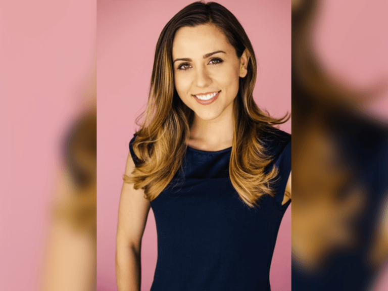 Voice actor Abby Trott smiling in front of a pink backdrop.