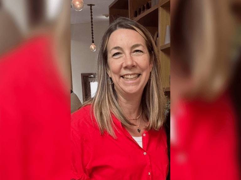 Casting Director Kristy Carlson smiling inside wearing a red sweater.