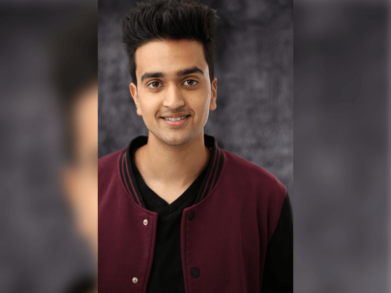 Actor Teja Chillara smiling in a burgundy bomber jacket.