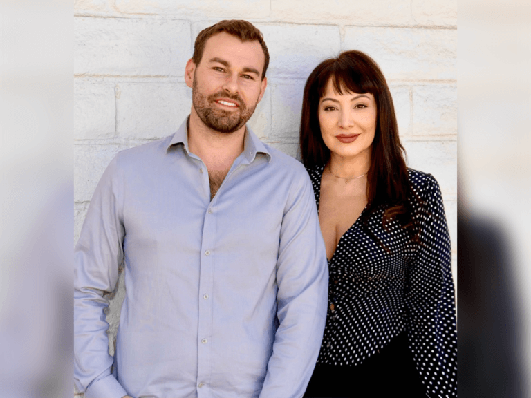 Casting Directors Sande Alessi and Shayne Hartigan standing in front of a brick wall smiling.