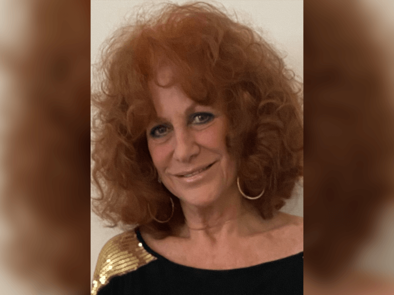 Casting Director Ellen Jacoby smiling in a black and gold outfit.