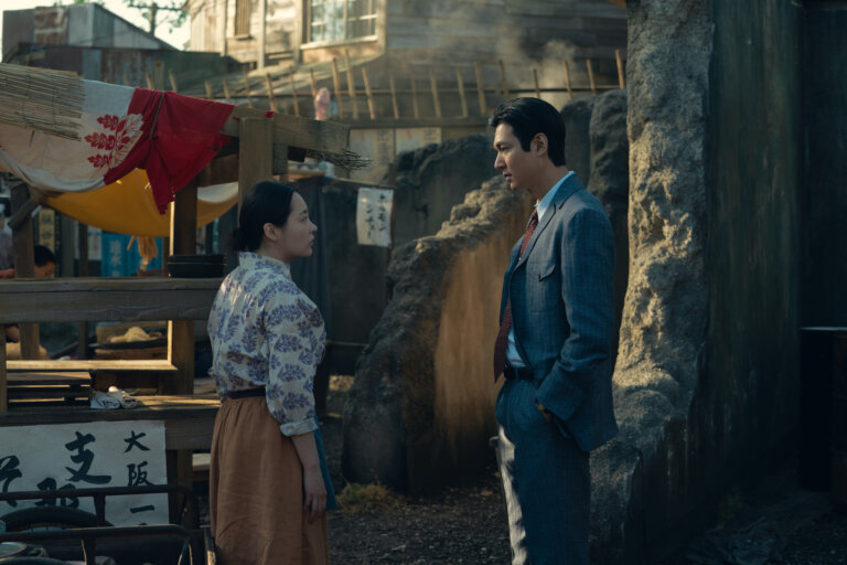 Minha Kim and Lee Minho in "Pachinko" at a Japanese village talking.