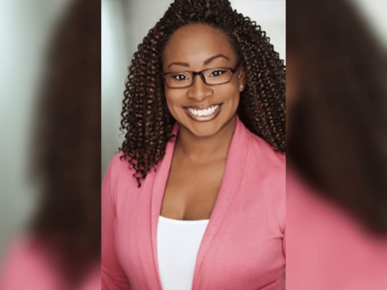 Actor Rosetta Tate smiling in a pink blazer.