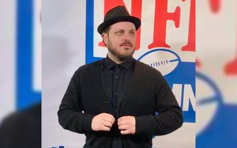 Casting director, actor and producer Justin Nesbitt smiling at an NFL event.