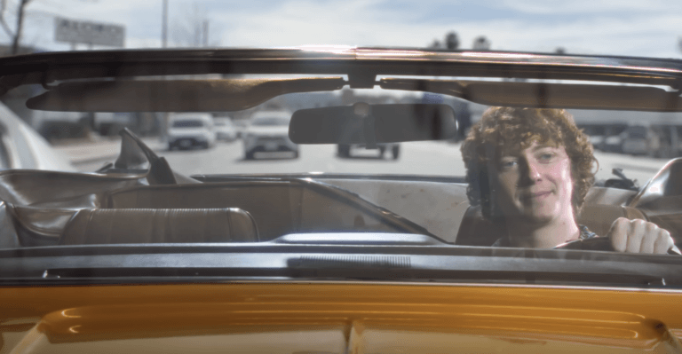 Morgan Seiter driving a yellow car in a commercial