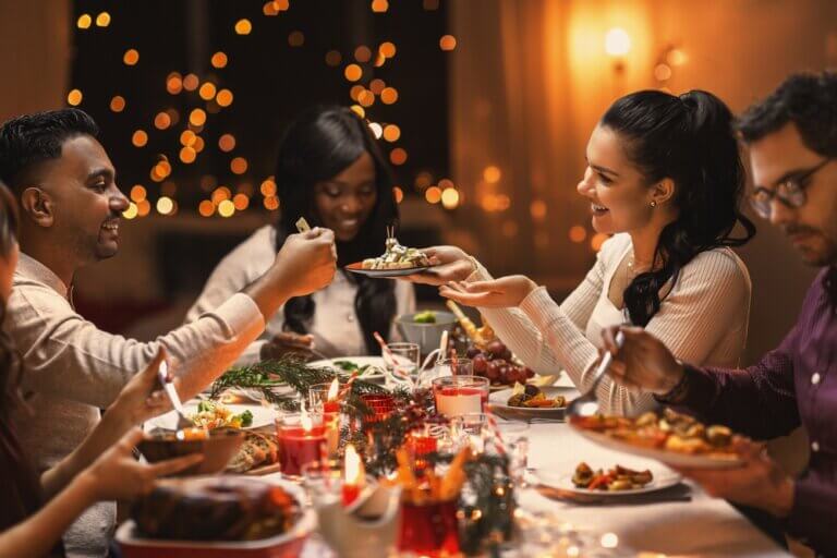 Diverse group of friends having dinner at a holiday party.