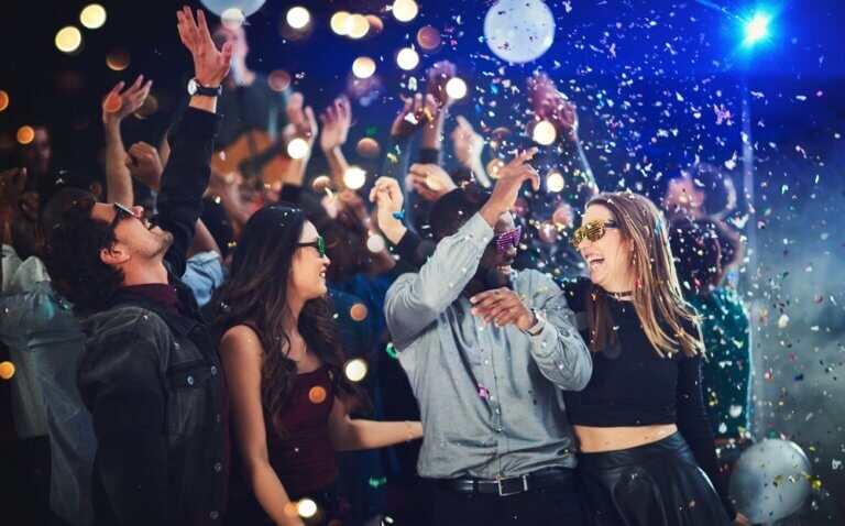 Diverse friends having a New Year's celebration with confetti.