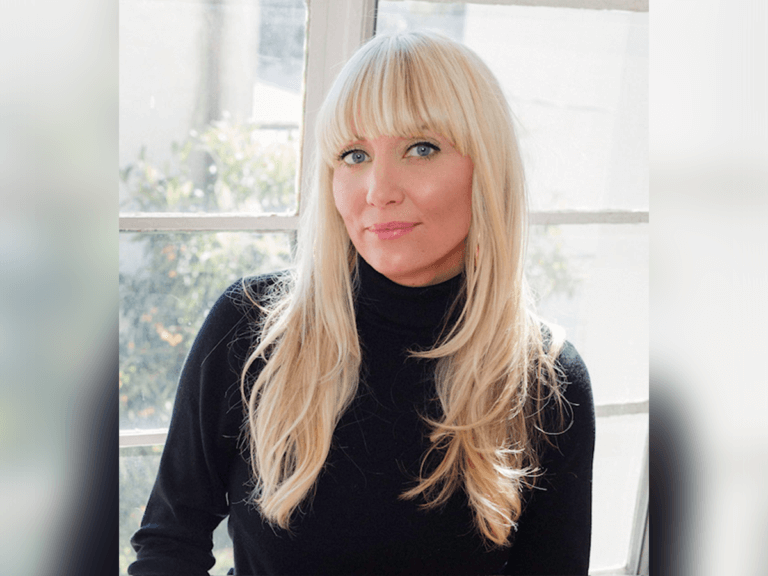Indie film casting director Amey René. smiling indoors wearing a black turtleneck sweater.