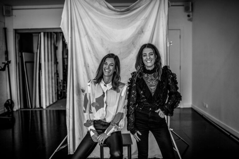 Black and white photo of Casting director team Alison Fowler and Stephanie Pringle smiling in a studio.