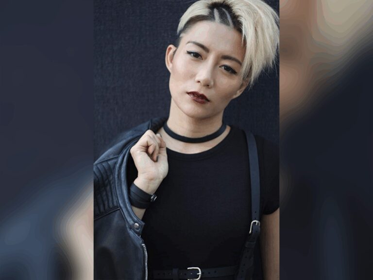 Juju Chan Szeto sporting a leather jacket and goth makeup looking tough.