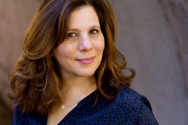 Casting director Stephanie Klapper smiling in a blue dress shirt.