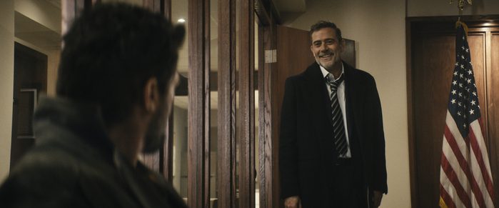Jeffrey Dean Morgan smiling in a suit inside a government office as Joe Kessler on The Boys.
