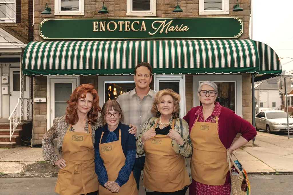 Susan Sarandon, Vince Vaughn, Brenda Vaccaro, Lorraine Bracco and Talia Shire standing outside an Italian restaurant on a quiet Staten Island street.