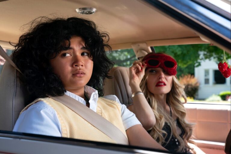 Chloe Fineman and Sam Morelos sitting in a car looking concerned.