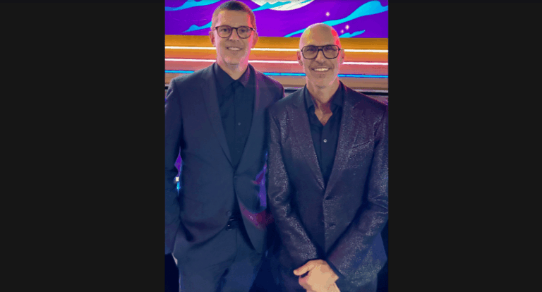 Casting directors Collin Daniel and Brett Greenstein smiling in matching blue suits.