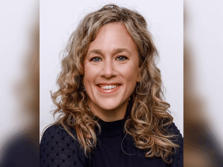 Casting Director Meg Morman smiling in a black sweater.