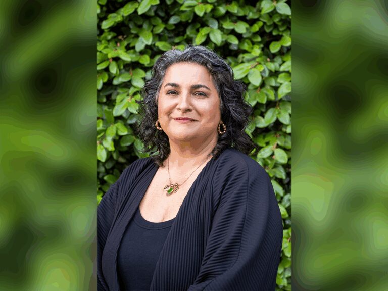 Casting Director Shaheen Baig standing and smiling in a garden with a black outfit.