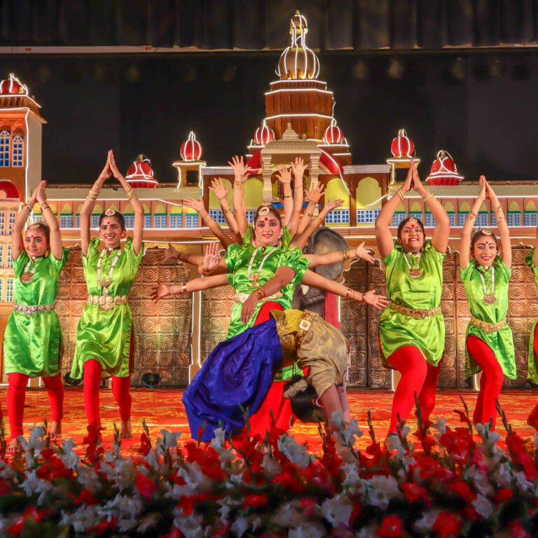 Bharatanatyam dance theater depicting Goddess Durga performed in traditional Indian saris.