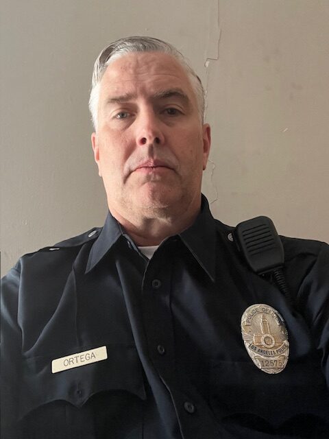 Mike Knox wearing his corrections officer uniform looking tough.