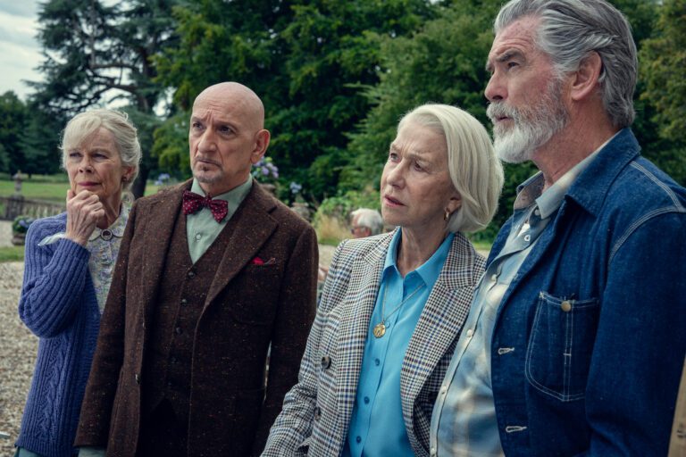 Helen Mirren, Ben Kingsley, Celia Imrie and Pierce Brosnan wearing nice suits outside looking inquisitive.