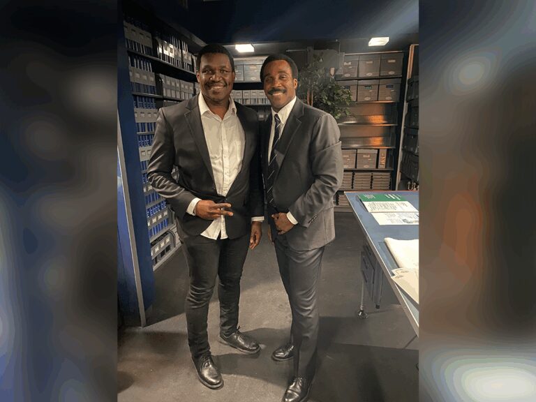 Justin Dinkins & Tramell Tillman on the set of Severance wearing suits in an office data room.