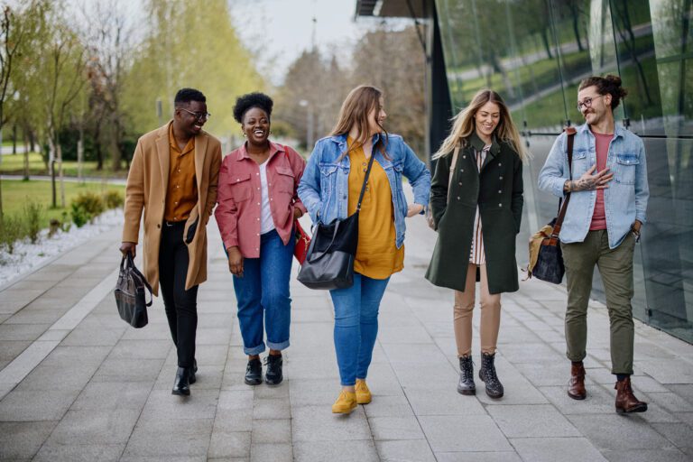 Diverse group of friends at college students having fun after studying.