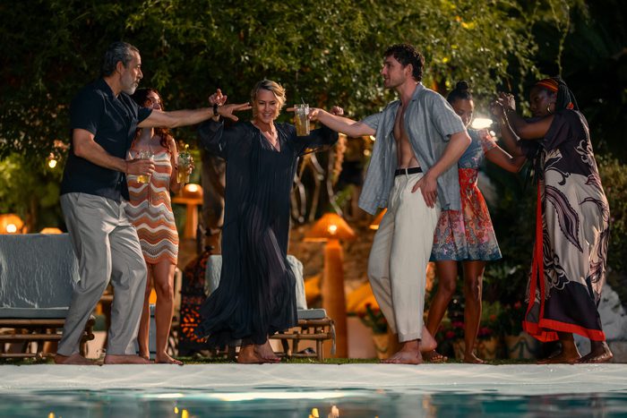 Howard Sanderson (Waleed Zuaiter), Laura Sanderson (Robin Wright) , and Daniel Sanderson (Laurie Davidson) dancing at a pool party in THE GIRLFRIEND.