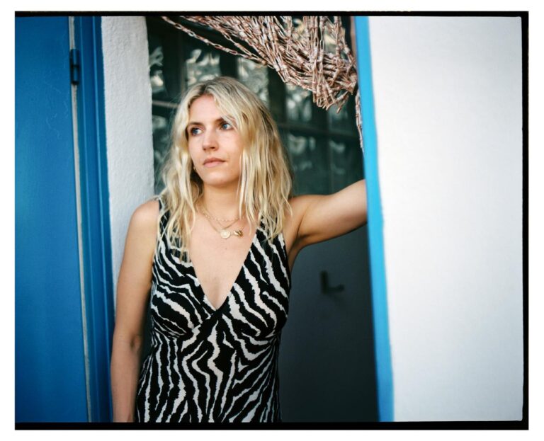 casting director Georgia Topley standing in the doorway of her home.
