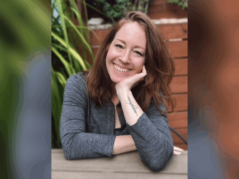 Casting Director Jessica Munks smiling outside in a grey sweater.