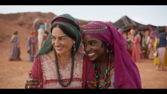 Wasim No'madi and Shereen Khan in the desert wearing traditional robes.